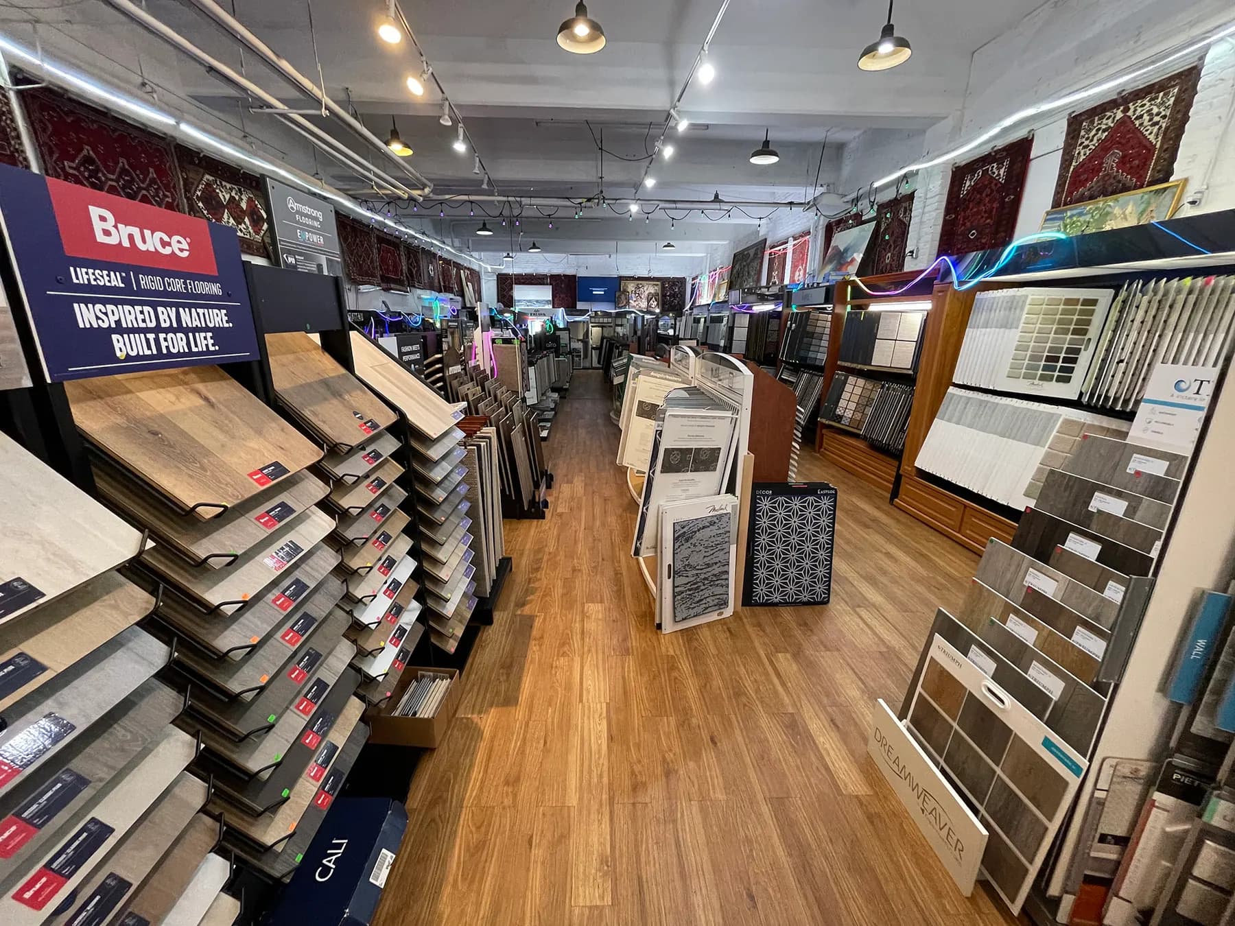 Flooring sample racks and hanging rugs inside the Capital Carpet showroom